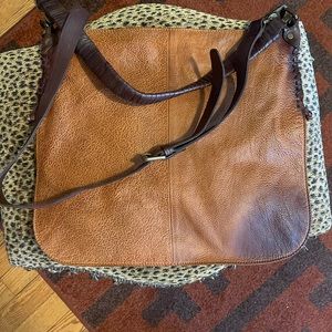 This is a brown We The Free over-the-shoulder bag.
